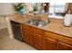 Galley kitchen with stainless steel dishwasher, granite countertops and tile flooring at 13427 Blue Heron Beach Dr # 1607, Orlando, FL 32821