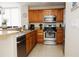 Kitchen features stainless steel appliances, wood cabinets, granite countertops and tile flooring at 13427 Blue Heron Beach Dr # 1607, Orlando, FL 32821