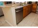 Kitchen features stainless steel appliances, granite countertops and wood cabinets and tile flooring at 13427 Blue Heron Beach Dr # 1607, Orlando, FL 32821