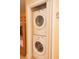A laundry nook featuring a stacked washer and dryer beside a bunk bed at 13427 Blue Heron Beach Dr # 1607, Orlando, FL 32821