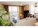 Bright living space with a balcony, comfortable seating, and dining area, perfect for relaxation at 13427 Blue Heron Beach Dr # 1607, Orlando, FL 32821