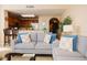 Cozy living room with stylish sofas, open to the kitchen and dining area at 13427 Blue Heron Beach Dr # 1607, Orlando, FL 32821