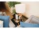 Close up on living room decor including a stylish lamp, table, and plush seating at 13427 Blue Heron Beach Dr # 1607, Orlando, FL 32821