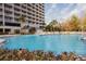 Enjoy the community pool with palms and lounge chairs at this fantastic condo at 13427 Blue Heron Beach Dr # 1607, Orlando, FL 32821
