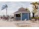 A pool bar in a resort setting with lounge chairs, tables, and palm trees at 13427 Blue Heron Beach Dr # 1607, Orlando, FL 32821