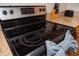 Close up of stove top with black cooktop, silver trim and granite countertops at 13427 Blue Heron Beach Dr # 1607, Orlando, FL 32821