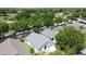 Aerial view showing the property, screened pool and lush green landscaping at 1361 Rebecca Dr, Haines City, FL 33844