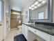 Bathroom features a glass-enclosed shower, granite counters and vanity area at 1361 Rebecca Dr, Haines City, FL 33844