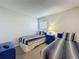 Comfortable bedroom featuring twin beds, blue furnishings, and a bright window at 1361 Rebecca Dr, Haines City, FL 33844