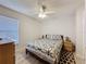 Well-lit bedroom with a ceiling fan, a queen bed, and hardwood-style floors at 1361 Rebecca Dr, Haines City, FL 33844