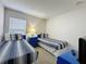 Bright bedroom with twin beds, blue accents, and natural light from the window at 1361 Rebecca Dr, Haines City, FL 33844