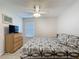 Bright bedroom with a ceiling fan and a queen bed with hardwood-style floors at 1361 Rebecca Dr, Haines City, FL 33844