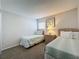 Cozy bedroom with two twin beds, soft carpeting, and a relaxing atmosphere at 1361 Rebecca Dr, Haines City, FL 33844
