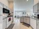 Bright kitchen features tile floors, granite counters, gray cabinets, and white appliances at 1361 Rebecca Dr, Haines City, FL 33844