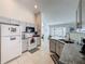 Well-lit kitchen with tile floors, granite countertops, gray cabinets, and white appliances at 1361 Rebecca Dr, Haines City, FL 33844