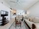 Open-concept living room includes tile floors, neutral walls, and a view of the kitchen at 1361 Rebecca Dr, Haines City, FL 33844