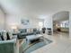 Bright living room showcasing neutral decor, tile flooring, and an archway leading to dining area at 1361 Rebecca Dr, Haines City, FL 33844