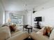 Cozy living room with ceiling fan, sliding glass doors to the patio, and neutral decor at 1361 Rebecca Dr, Haines City, FL 33844