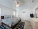 Spacious bedroom with a large bed, stylish rug and wood-look flooring at 1361 Rebecca Dr, Haines City, FL 33844