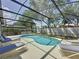 Screened-in pool with clear blue water and lounge chairs for relaxing in the sun at 1361 Rebecca Dr, Haines City, FL 33844