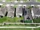 An aerial view shows backyard with trampoline and solar panels on roof at 1371 Red Blossom Ln, Kissimmee, FL 34746