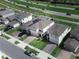 Community aerial view displaying multiple homes, green spaces, and vehicle traffic at 1371 Red Blossom Ln, Kissimmee, FL 34746