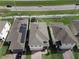 Aerial view of homes with solar panels, green lawns, backyard trampoline and lush landscaping at 1371 Red Blossom Ln, Kissimmee, FL 34746