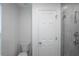 A sleek bathroom features a tiled shower with glass door, modern fixtures, and white door at 1371 Red Blossom Ln, Kissimmee, FL 34746
