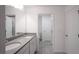 Modern bathroom with double sinks, quartz countertop, and a view of a tile shower at 1371 Red Blossom Ln, Kissimmee, FL 34746