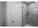 Bathroom features tiled shower with glass door, modern fixtures, and white door at 1371 Red Blossom Ln, Kissimmee, FL 34746