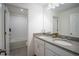 Bright bathroom features a double vanity with stone counters and tiled floor at 1371 Red Blossom Ln, Kissimmee, FL 34746