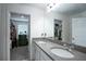 Bathroom with double sinks, modern countertops, and closet storage at 1371 Red Blossom Ln, Kissimmee, FL 34746