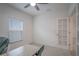 Bright, carpeted room with a desk, ceiling fan, and a door leading to another room at 1371 Red Blossom Ln, Kissimmee, FL 34746