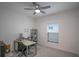 Cozy bedroom or office space with neutral colors, modern desk, and a ceiling fan at 1371 Red Blossom Ln, Kissimmee, FL 34746