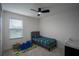 Well-lit bedroom featuring carpet, a ceiling fan, and a bed with colorful bedding at 1371 Red Blossom Ln, Kissimmee, FL 34746