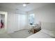 Well-lit bedroom featuring carpet, a ceiling fan, a bed with modern bedding, and closet doors at 1371 Red Blossom Ln, Kissimmee, FL 34746