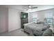 Bright bedroom featuring neutral tones, a ceiling fan, and a large window at 1371 Red Blossom Ln, Kissimmee, FL 34746