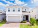 Charming two-story home featuring an attached two-car garage and well-manicured front lawn at 1371 Red Blossom Ln, Kissimmee, FL 34746