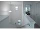 Bright hallway with pendant lighting leads to bedroom, featuring neutral paint and natural light at 1371 Red Blossom Ln, Kissimmee, FL 34746