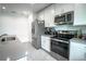 Contemporary kitchen featuring stainless steel appliances and sleek cabinetry at 1371 Red Blossom Ln, Kissimmee, FL 34746