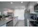 Modern kitchen featuring stainless steel appliances, granite countertops, and tiled floors at 1371 Red Blossom Ln, Kissimmee, FL 34746