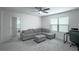 Living room with a couch, carpeted floor, and a ceiling fan at 1371 Red Blossom Ln, Kissimmee, FL 34746