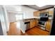 Modern kitchen featuring stainless steel appliances, wood cabinets, and an open layout at 151 E Washington St # 327, Orlando, FL 32801