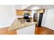 Functional kitchen with stainless steel appliances, granite countertop, and wood cabinetry at 151 E Washington St # 327, Orlando, FL 32801