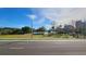 Scenic park view featuring green spaces, mature trees, and a lake under a blue sky at 151 E Washington St # 327, Orlando, FL 32801