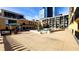 Beautiful outdoor pool and deck surrounded by yellow condominium buildings and a modern high-rise against blue skies at 151 E Washington St # 327, Orlando, FL 32801