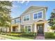 Charming two-story home with well-manicured lawn and a welcoming front porch at 15687 Kinnow Mandarin Ln, Winter Garden, FL 34787
