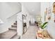Bright foyer featuring tile flooring, staircase, and a view of the living and dining areas at 15687 Kinnow Mandarin Ln, Winter Garden, FL 34787