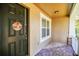 Inviting front porch featuring brick pathway, manicured landscaping, and a stylish front door at 15687 Kinnow Mandarin Ln, Winter Garden, FL 34787