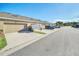 Row of garages at property, with a driveway, lawn and several cars parked along the street at 15687 Kinnow Mandarin Ln, Winter Garden, FL 34787